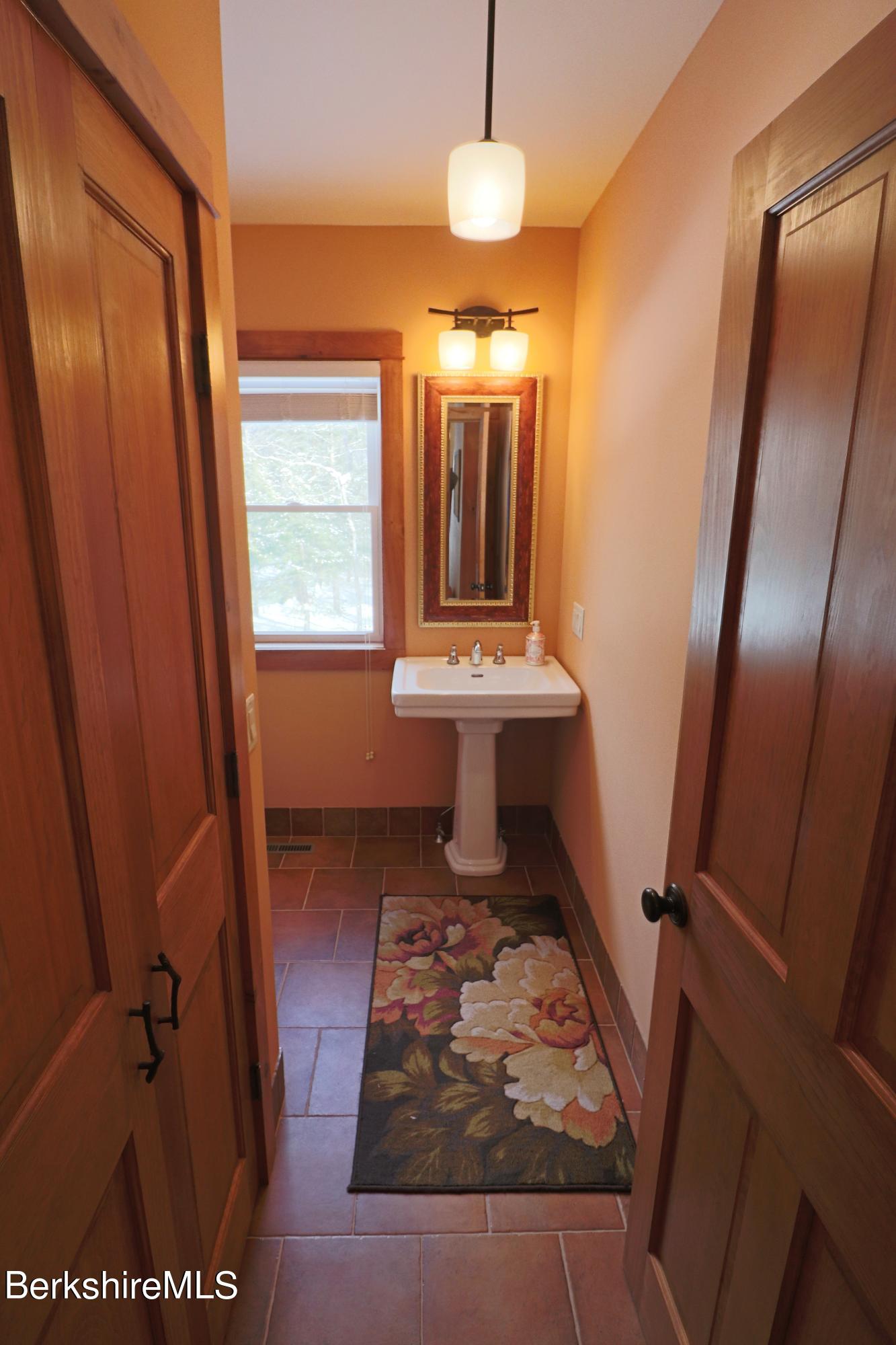 453 Ed Jones Road Otis, MA 01253 - Photo 22 of 41 a bathroom with a sink a mirror and a shower