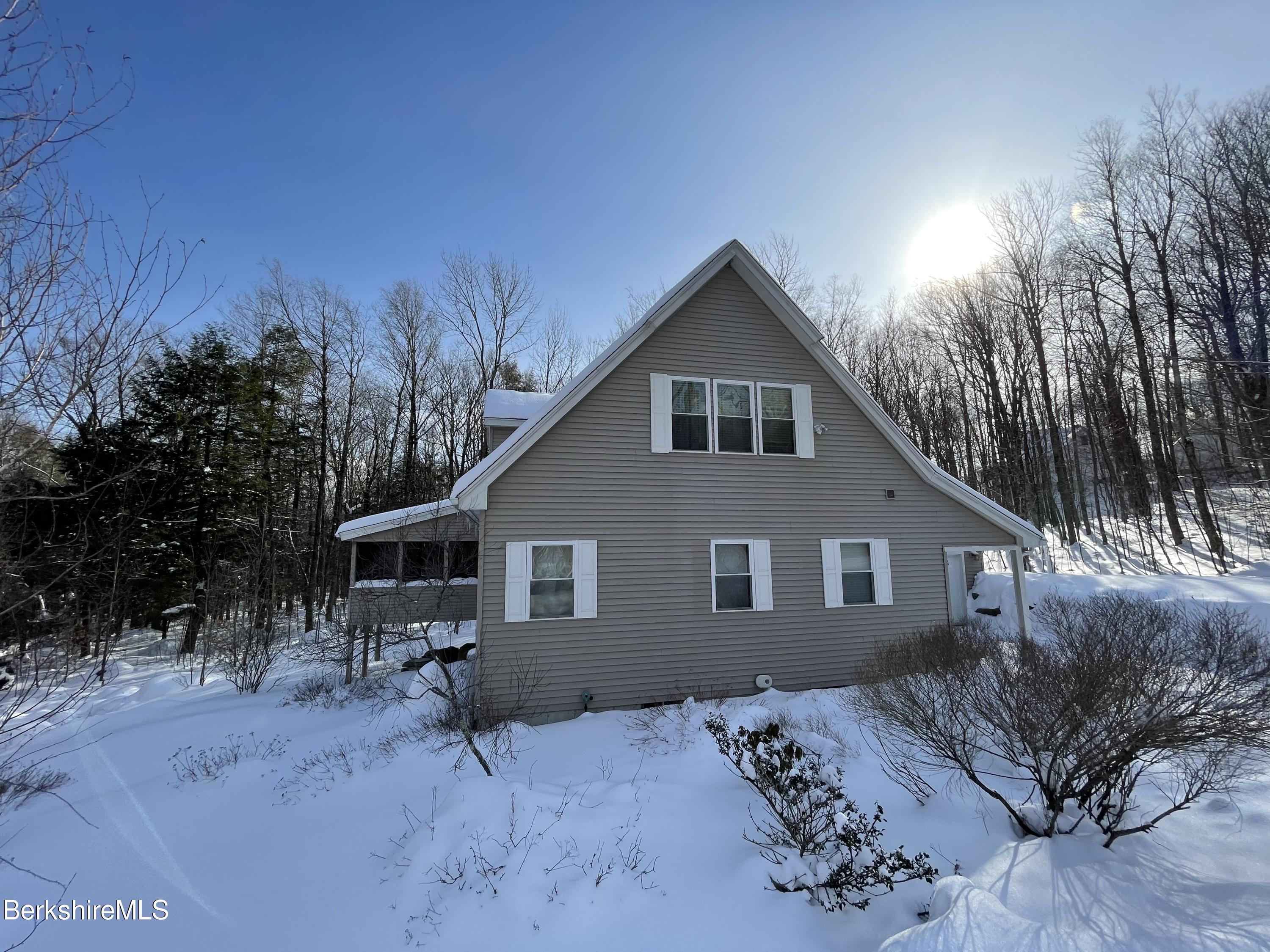 453 Ed Jones Road Otis, MA 01253 - Photo 4 of 41 a front view of a house with a yard