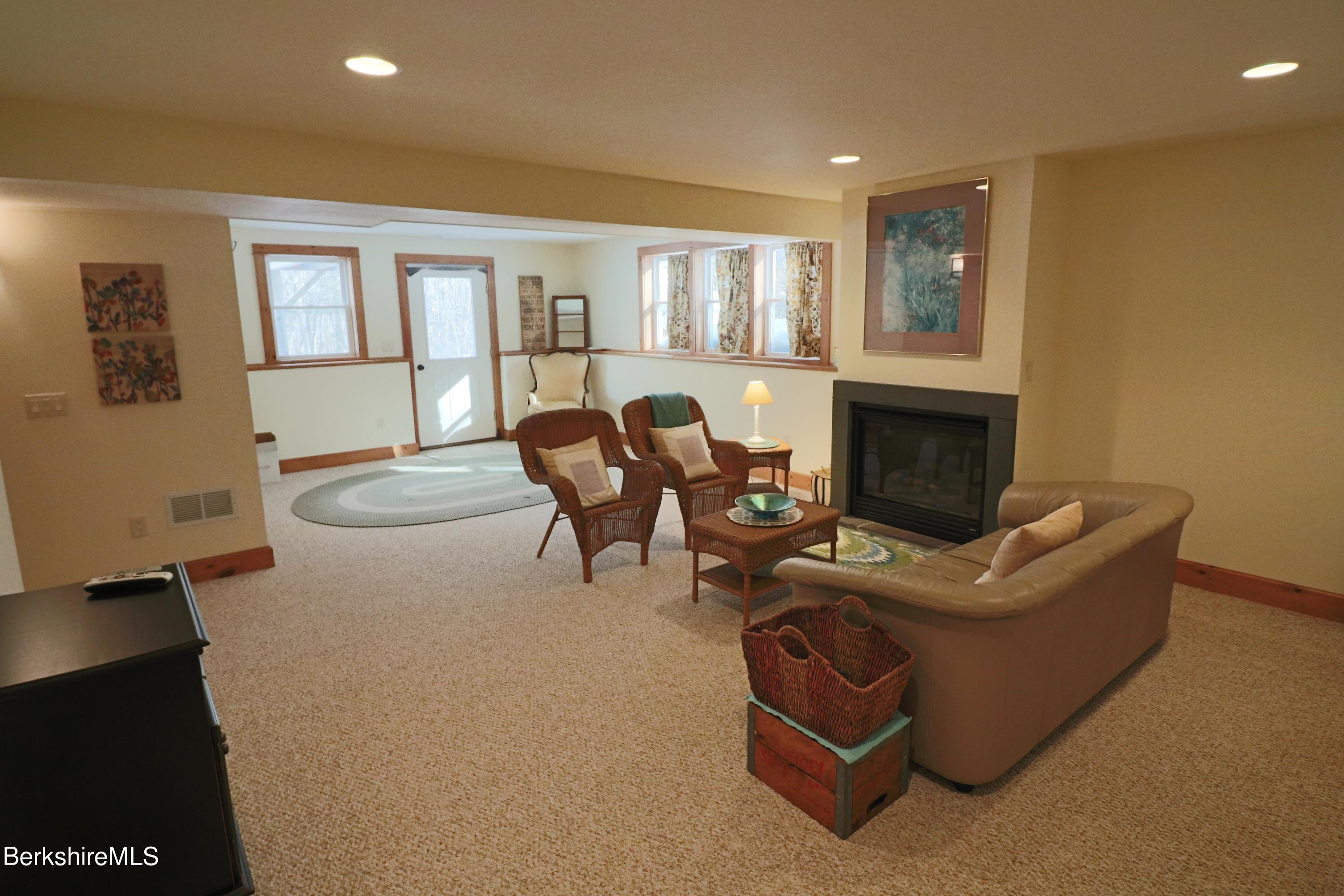 453 Ed Jones Road Otis, MA 01253 - Photo 34 of 41 a living room with furniture and a fireplace