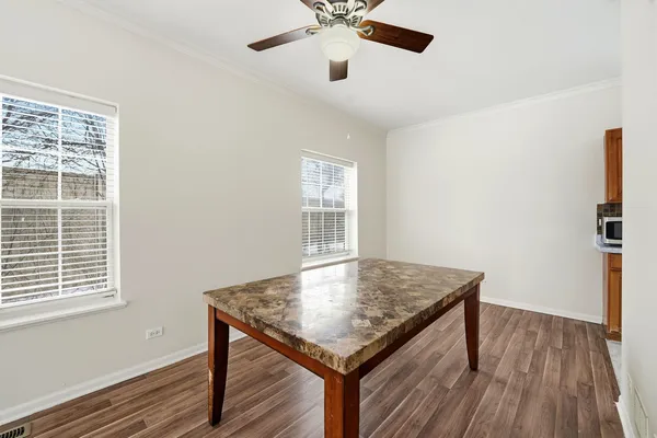 a living room with wooden floor and a window