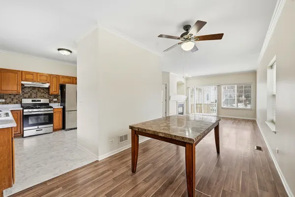 a kitchen with a table chairs and a chandelier