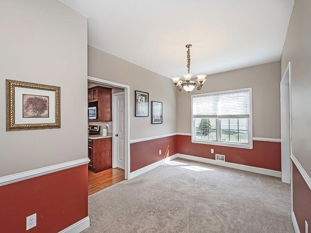 223 Arrowhead Lane Eighty Four, PA 15330 - Photo 19 of 42 a spacious bedroom with a large bed and a chandelier
