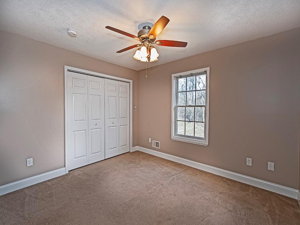 223 Arrowhead Lane Eighty Four, PA 15330 - Photo 34 of 42 an empty room with windows and fan