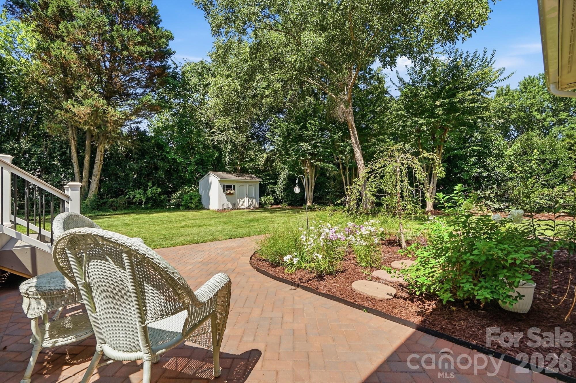 1136 Concord Road Davidson, NC 28036 - Photo 26 of 34 a view of a house with backyard sitting area and garden