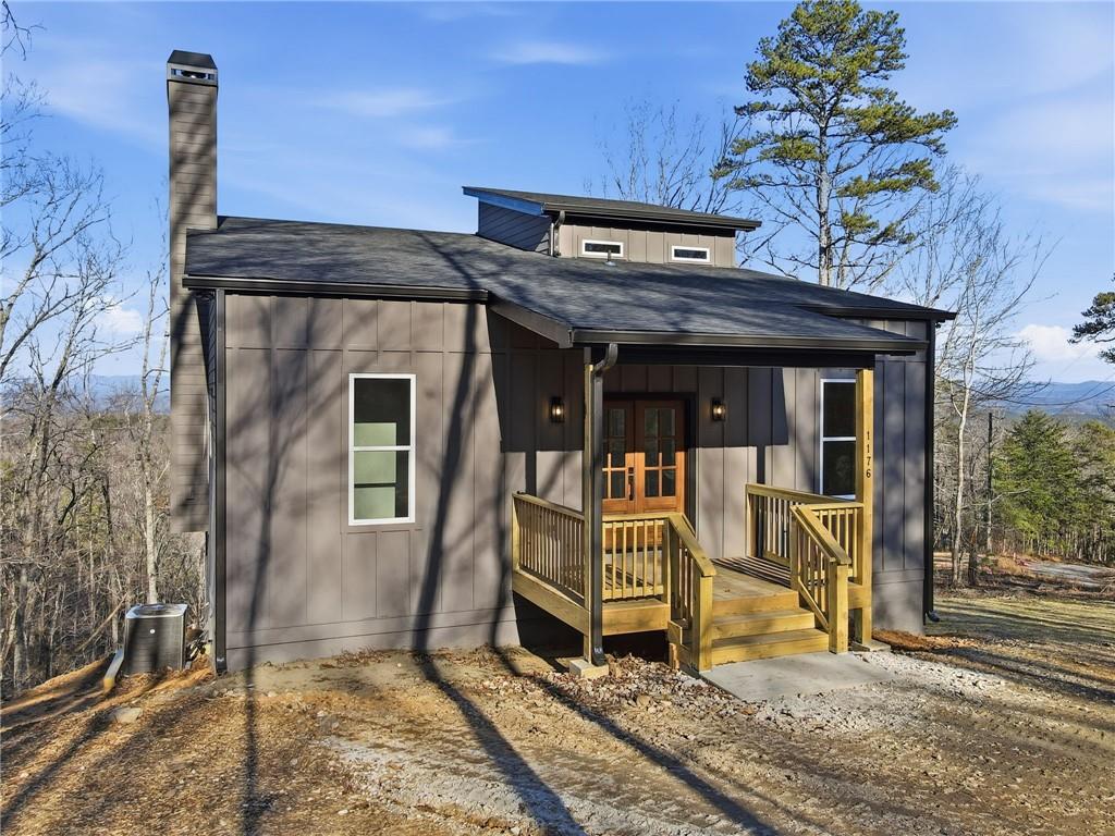 a view of a house with a large window and wooden fence