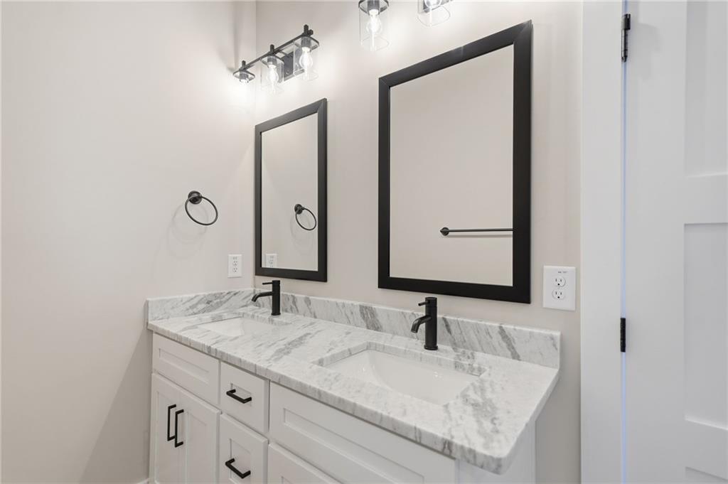 1176 Jewel Court Northeast Ranger, GA 30734 - Photo 28 of 58 a bathroom with a granite countertop sink and a mirror