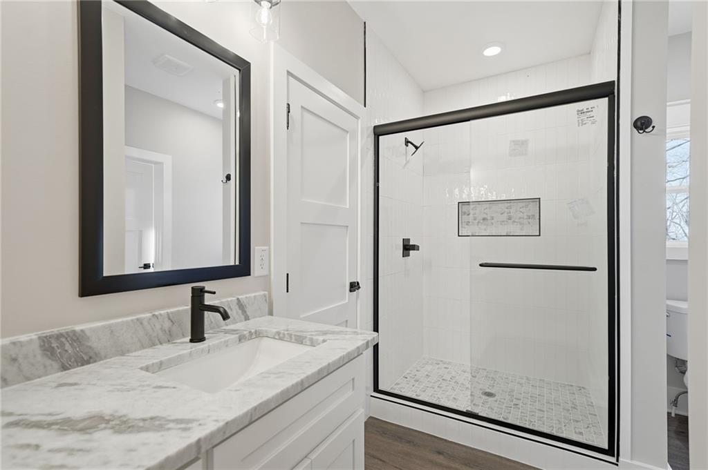 1176 Jewel Court Northeast Ranger, GA 30734 - Photo 29 of 58 a bathroom with a granite countertop sink mirror and a shower