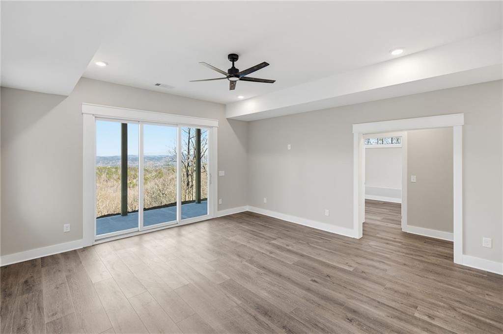 1176 Jewel Court Northeast Ranger, GA 30734 - Photo 33 of 58 an empty room with wooden floor and windows