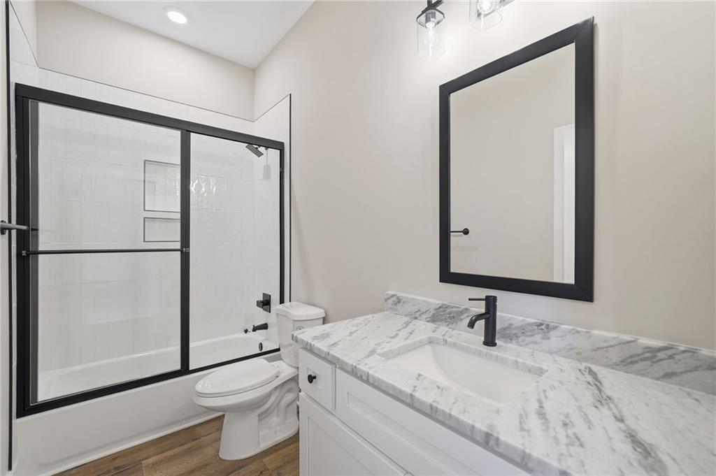 1176 Jewel Court Northeast Ranger, GA 30734 - Photo 38 of 58 a bathroom with a granite countertop sink toilet and mirror