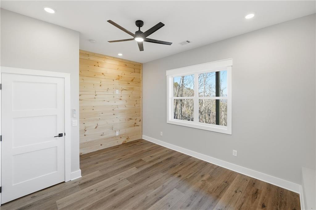 1176 Jewel Court Northeast Ranger, GA 30734 - Photo 39 of 58 an empty room with wooden floor and windows
