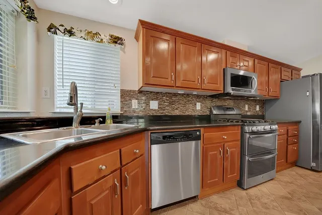 en empty room with windows and chandelier fan