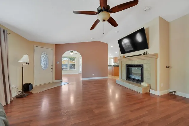 a view of a livingroom with a couch and a chandelier fan