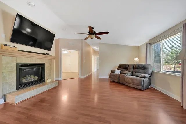 an empty room with a window and a fan