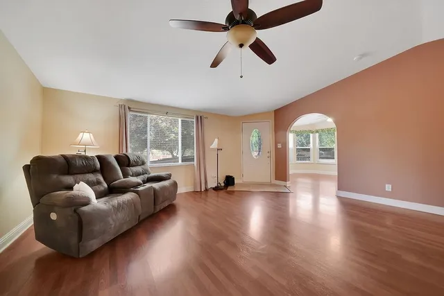 an empty room with a chandelier fan and closet area