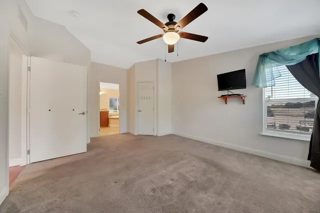 a view of a house with a small yard and wooden fence
