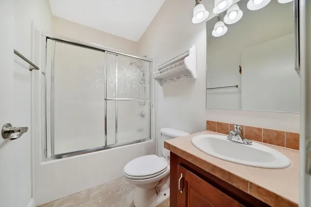 a backyard of a house with lots of green space and outdoor seating