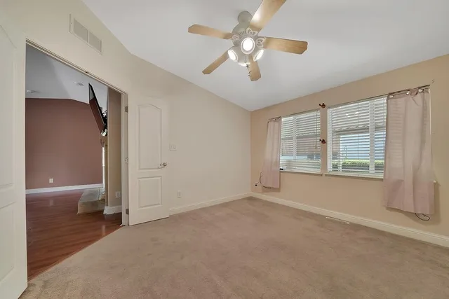 a view of backyard with wheel chair potted plants and large tree