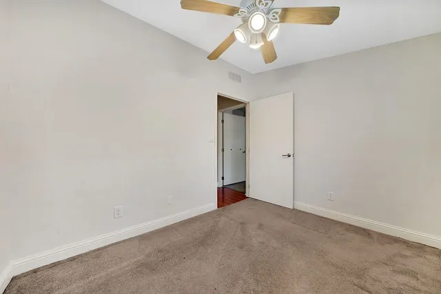 an aerial view of a house with a yard and a large tree
