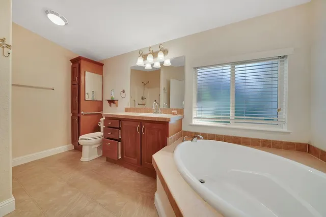 a house view with a sitting space fire pit and outdoor space