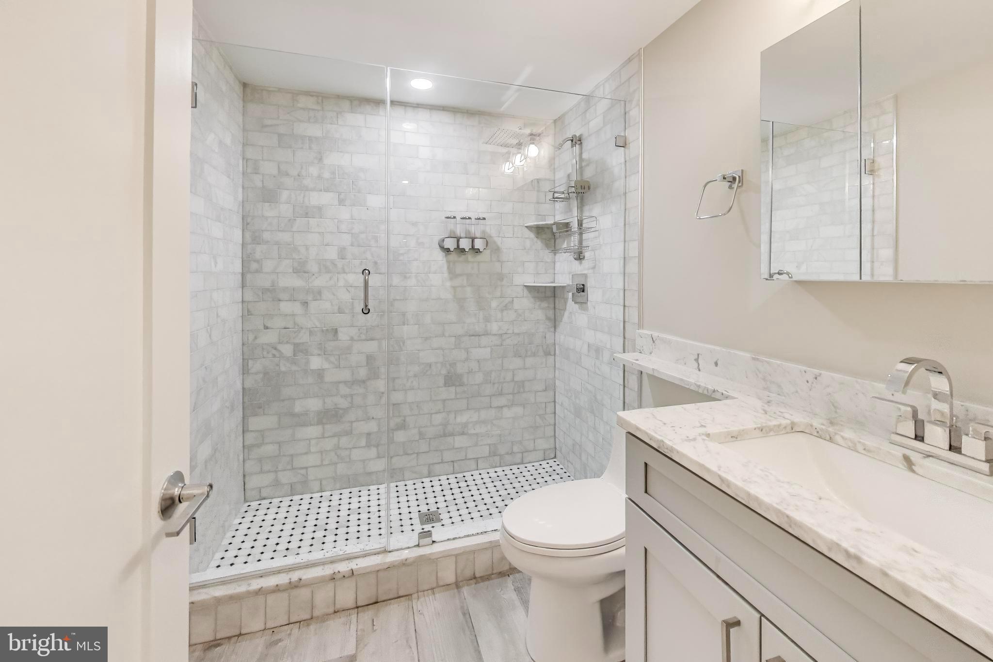 1444 Harvard Street Northwest, Unit 1 Washington, DC 20009 - Photo 13 of 19 Sleek modern bathroom with elegant finishes.