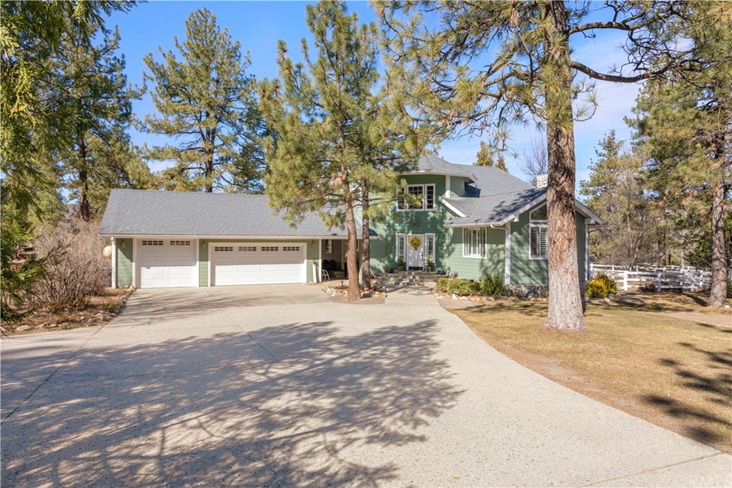 60900 Devils Ladder Road Mountain Center, CA 92561 - Photo 1 of 1 a front view of a house with a yard and garage