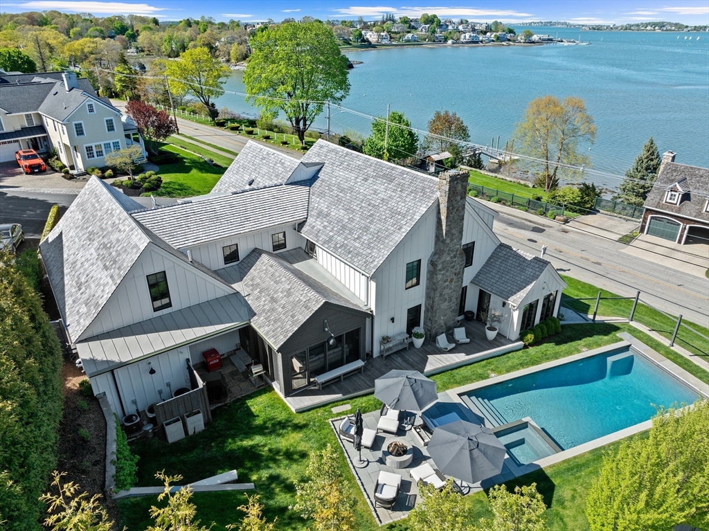 an aerial view of a house with garden space and ocean view