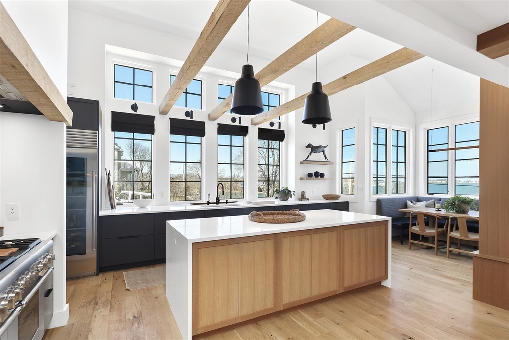 178 Otis Street Hingham, MA 02043 - Photo 11 of 41 a large kitchen with stainless steel appliances granite countertop a large stove a sink and a dishwasher next to a large window