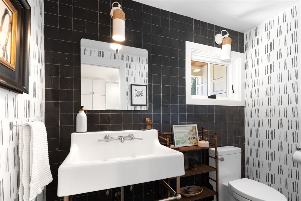 178 Otis Street Hingham, MA 02043 - Photo 21 of 41 a bathroom with a sink a toilet and mirror