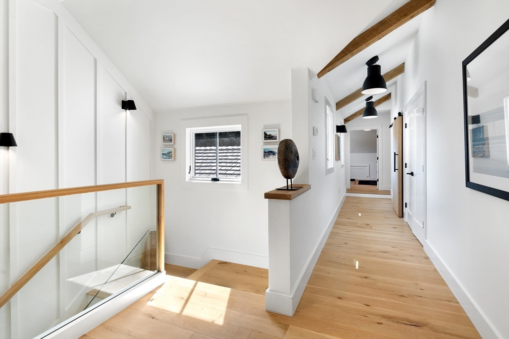 178 Otis Street Hingham, MA 02043 - Photo 23 of 41 a view of a hallway with windows and stairs