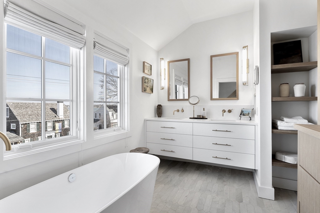 178 Otis Street Hingham, MA 02043 - Photo 25 of 41 a bathroom with a sink mirror and a bathtub