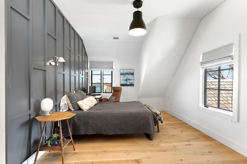 178 Otis Street Hingham, MA 02043 - Photo 28 of 41 a bedroom with a bed and a chandelier