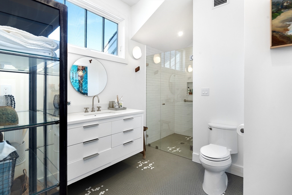 178 Otis Street Hingham, MA 02043 - Photo 31 of 41 a bathroom with a toilet a sink and mirror