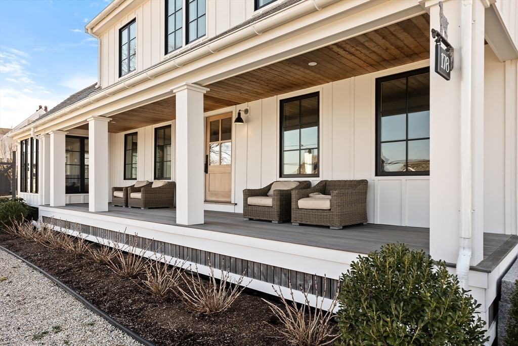 178 Otis Street Hingham, MA 02043 - Photo 5 of 41 a view of a house with a large window and wooden fence