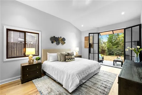 a bedroom with a large bed and a large window