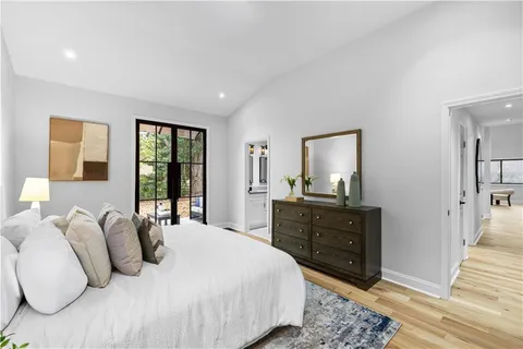 a bedroom with a bed and a mirror on dresser