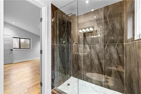 a bathroom with a glass shower door and a sink
