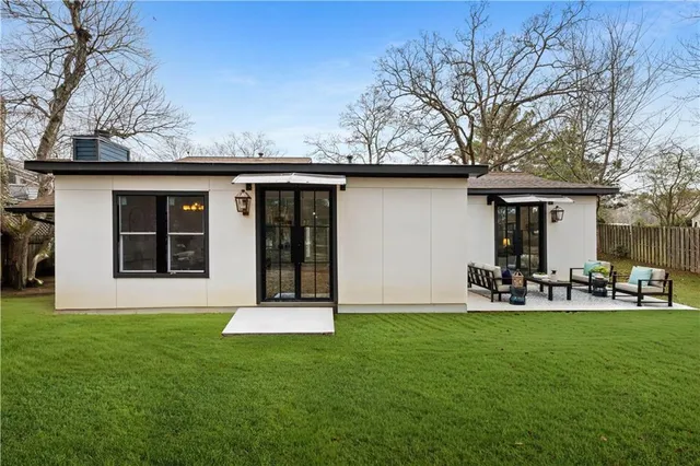 a front view of house with yard and outdoor seating
