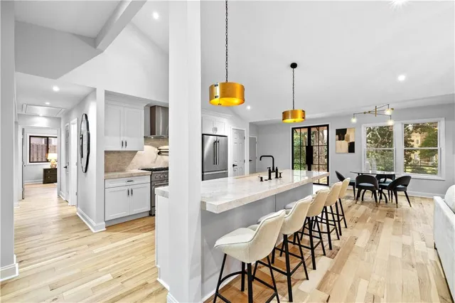 a very nice looking kitchen with granite countertop a large counter top appliances and cabinets