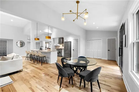 a view of a dining room with furniture and wooden floor