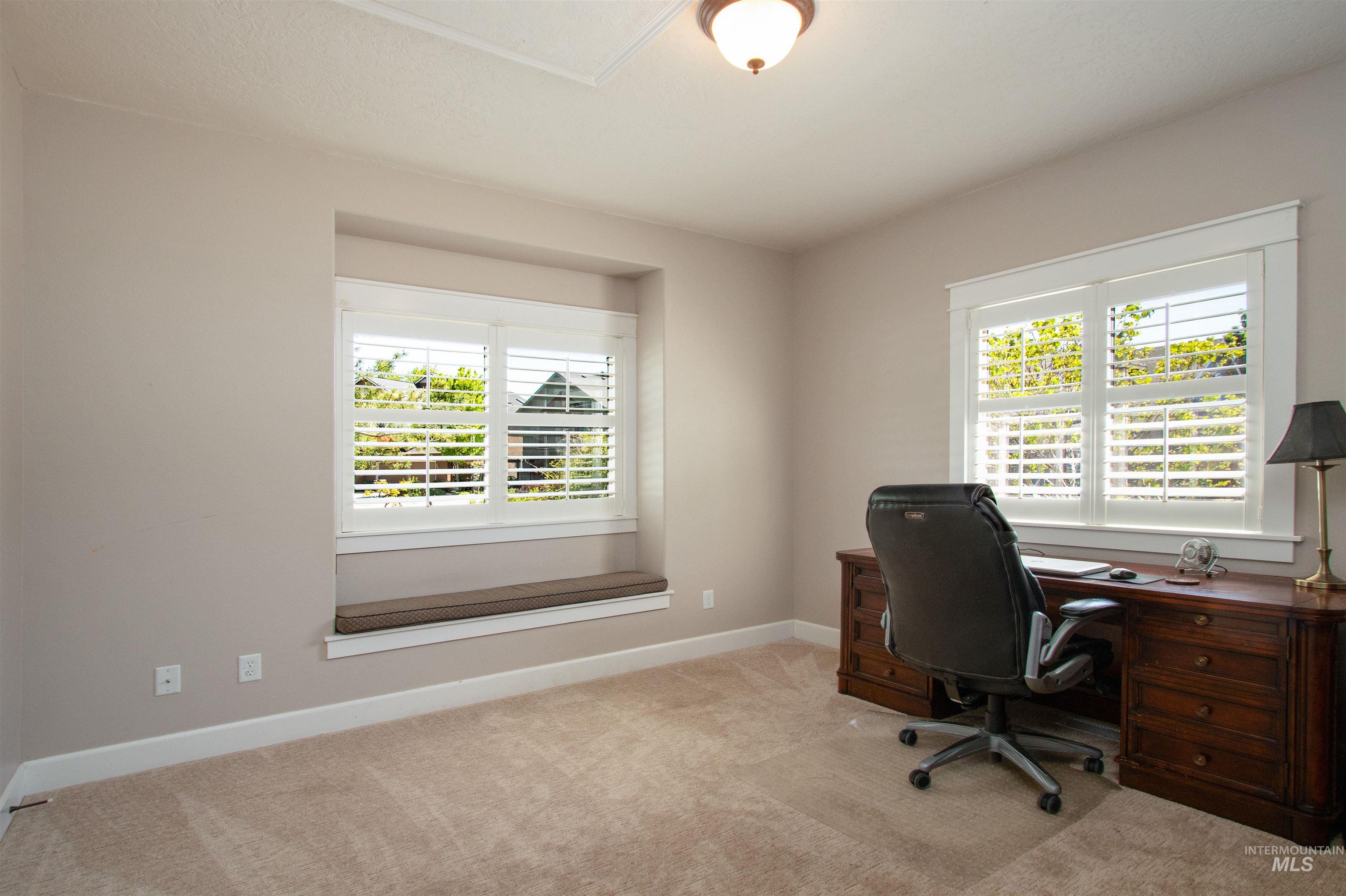 892 South Capitola Way Boise, ID 83712 - Photo 7 of 34 Room featuring neutral tone walls, plush carpeting, and two windows with plantation shutters