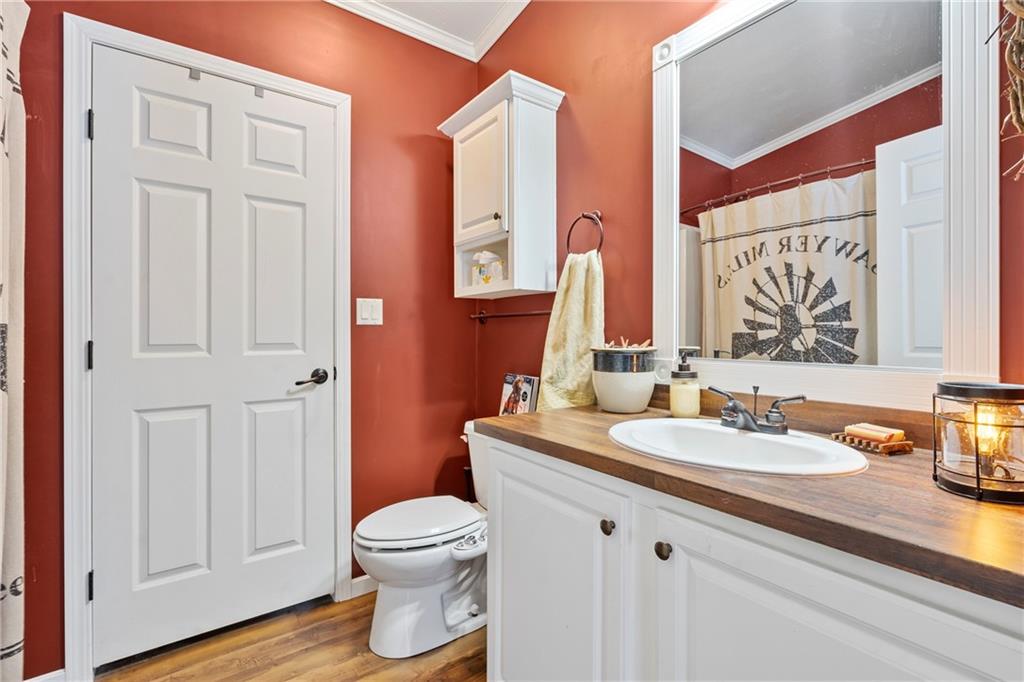 257 Hilltop Acres Road Slippery Rock, PA 16057 - Photo 16 of 25 a bathroom with a granite countertop sink toilet and mirror