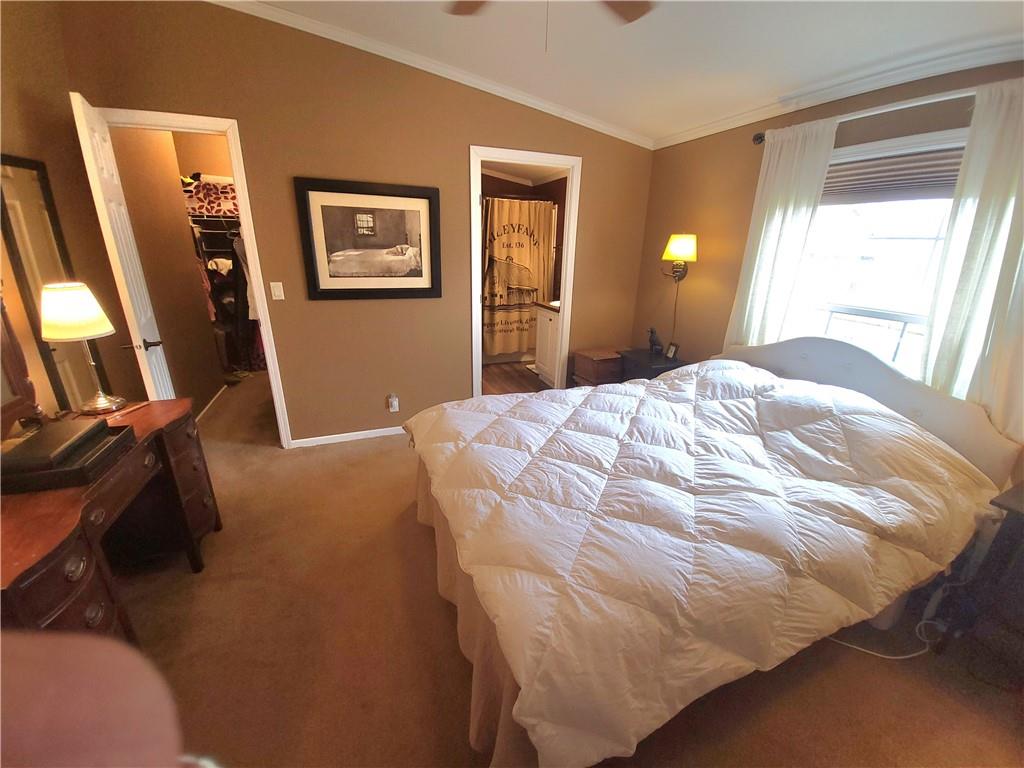 257 Hilltop Acres Road Slippery Rock, PA 16057 - Photo 9 of 25 a bedroom with a bed and a flat tv screen on dresser