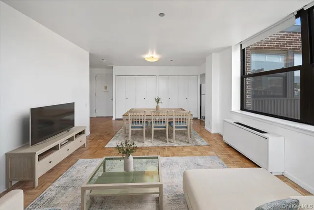 a living room with a flat screen tv and a large window