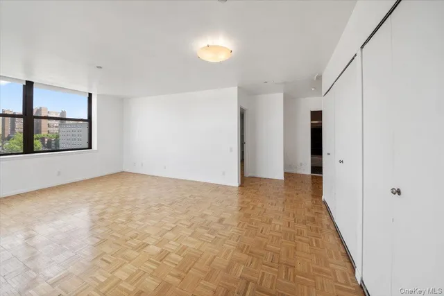 a view of hallway with an empty room and window