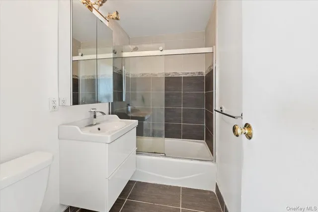 a bathroom with a shower a sink and a mirror