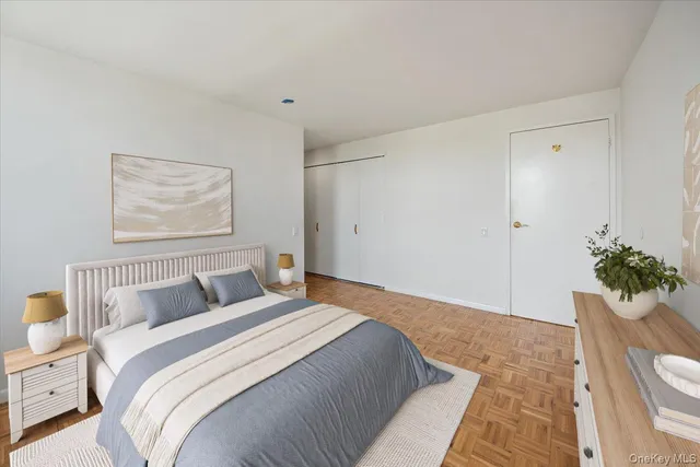 a bedroom with a bed and a potted plant