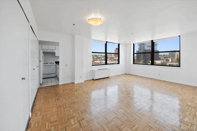 a view of empty room with a window and fireplace