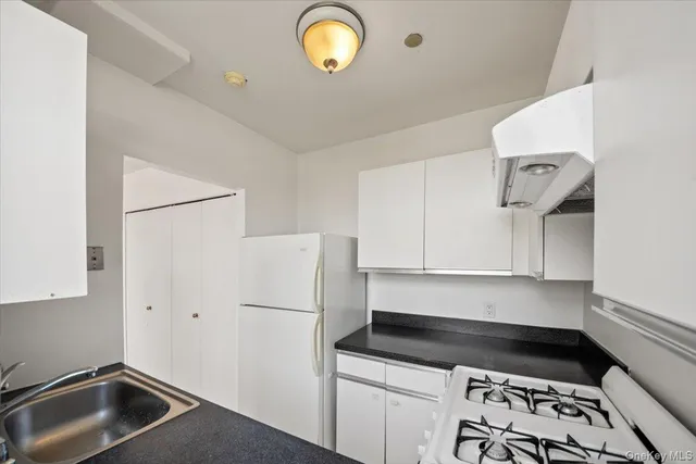 a kitchen with a refrigerator and a sink