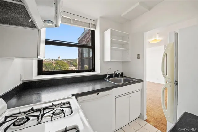 a kitchen with a sink stove and microwave