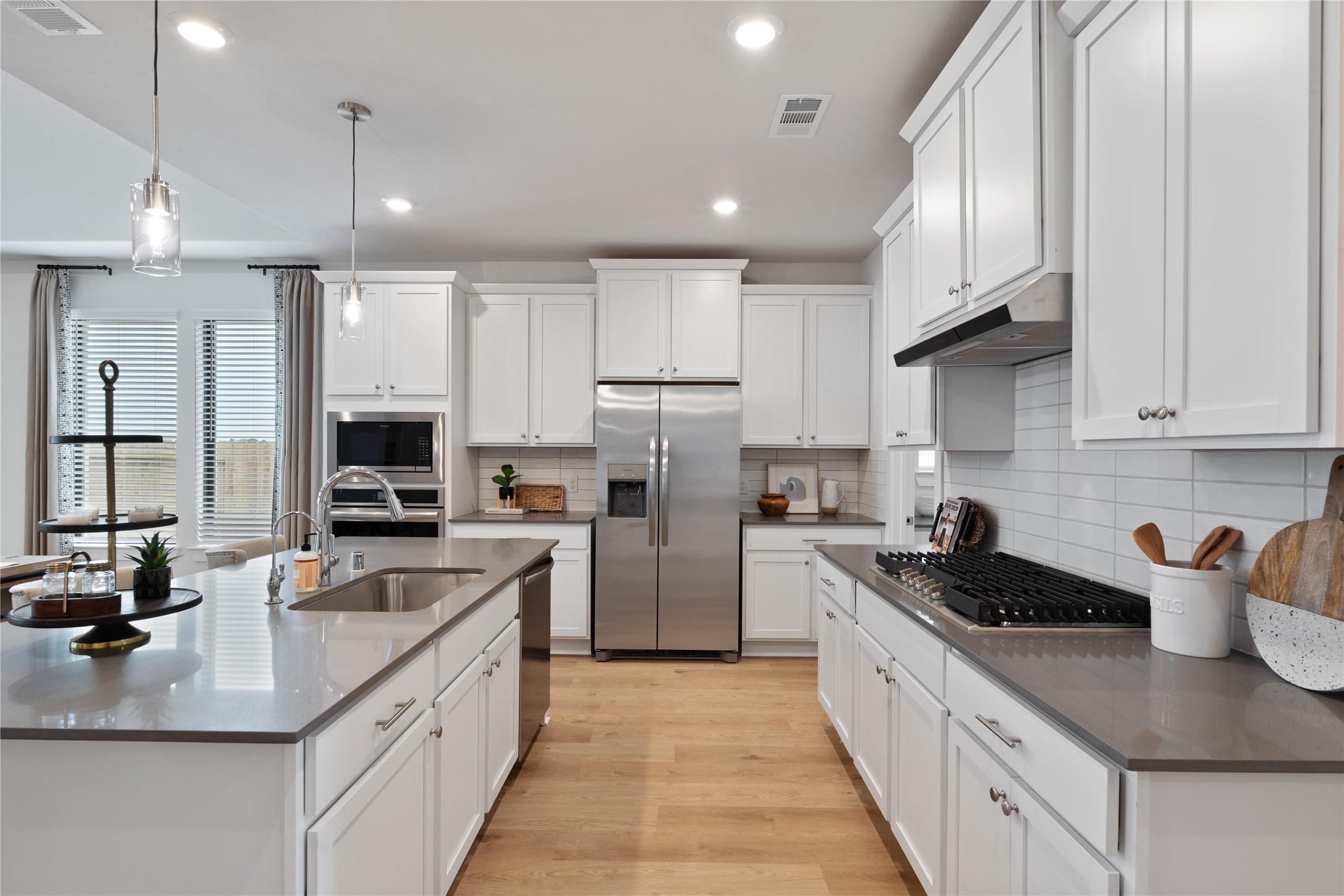 813 Green Ash Way Hempstead, TX 77445 - Photo 14 of 41 a kitchen with refrigerator a stove a sink and cabinets